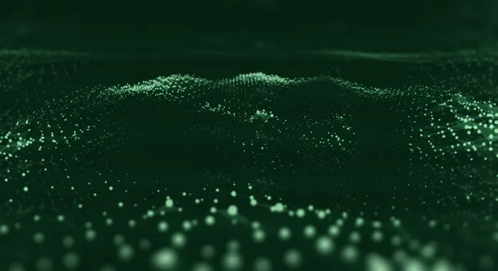Rolling dark hills dotted with soft green points of light, like fireflies over a night meadow