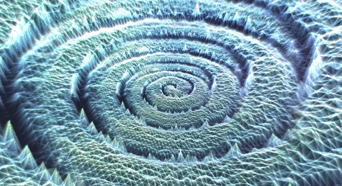A pale silver-blue spiral of frosted terrain ridges, swirling like a fingerprint