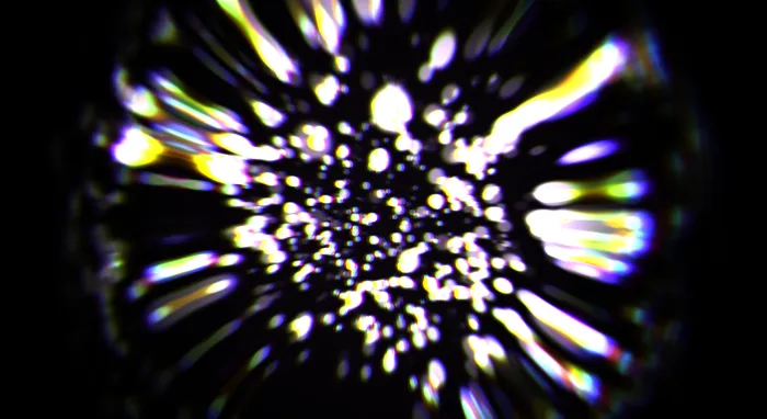 A burst of white and rainbow bokeh sparks scattering from the center