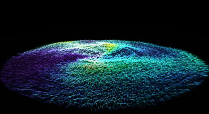 A thin disc of teal and violet particles floating in darkness like a distant galaxy seen edge-on